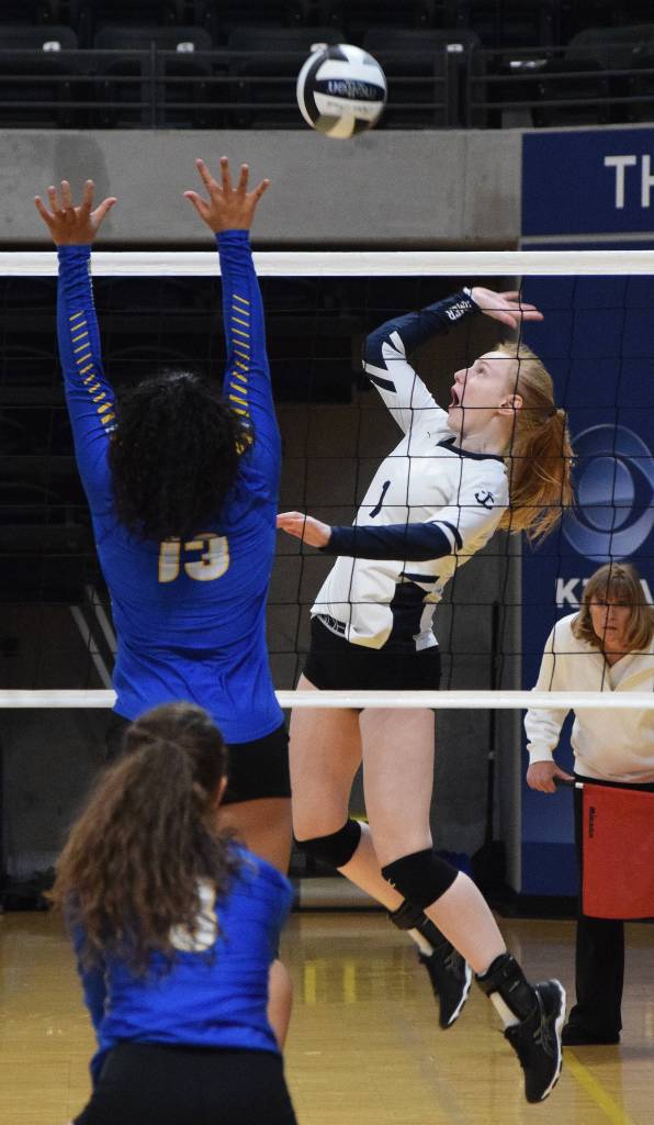 Homers Kelli Bishop winds up for a kill point against Barrows Sarah Mila (13) Friday at the Class 3A state volleyball tournament at the Alaska Airlines Center. (Photo by Joey Klecka/Peninsula Clarion)