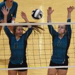 Nikiskis Emma Wik (6) and Bethany Carstens team up for a block Friday against Grace Christian at the Class 3A state volleyball tournament at the Alaska Airlines Center. (Photo by Joey Klecka/Peninsula Clarion)