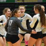 Nikiskis America Jeffreys (left), Kelsey Clark (17) and Kaycee Bostic (center) encourage each other Saturday near the end of the Class 3A state volleyball championship final against Valdez at the Alaska Airlines Center. (Photo by Joey Klecka/Peninsula Clarion)