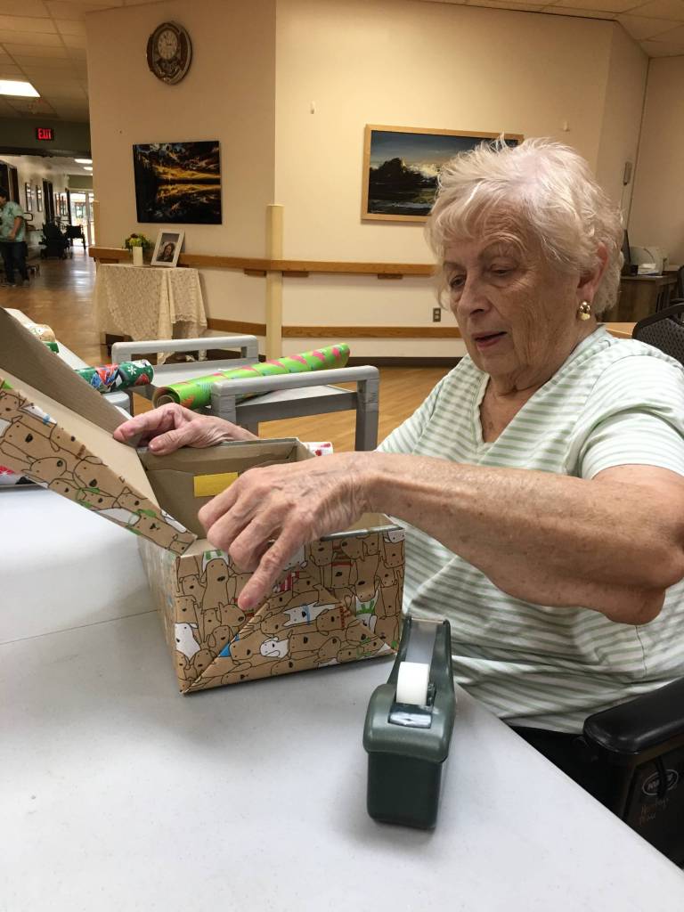 Heritage Place residents wrap holiday boxes with Samaritan’s Purse