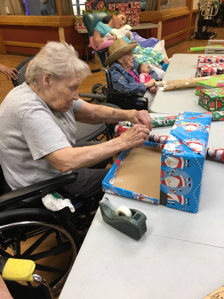 Heritage Place residents wrap holiday boxes with Samaritan’s Purse