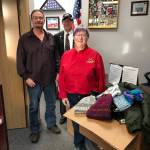 Kenai Elks Lodge Exalted Ruler Ken Cole and Kenai Elks Lodge Member Marti Slater present donated winter items to the Ronald Engebretson of the Kenai Vet Center on Wednesday in Kenai. (Courtesy photo)