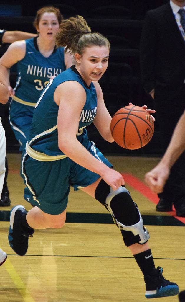 Nikiskis Bethany Carstens (right) dodges Barrow defender Jordan Ahgeak in the second half of a quarterfinal contest March 22, 2018, at the Class 3A state tournament at the Alaska Airlines Center. (Photo by Joey Klecka/Peninsula Clarion)