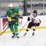 Service High School player Brent Edmonson looks for a place to pass the puck with Kenais Jordyn Stock close on his tail during a game Saturday during the End of the Road Shootout at Kevin Bell Arena in Homer. (Photo by Megan Pacer/Homer News)