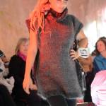 Britt Huffman models Grey Skies by Lynn Burt with a black leather bag by Mary Hayden at the 2018 Wearable Arts on Nov. 17, 2018, in Homer, Alaska. (Photo by Michael Armstrong/Homer News)