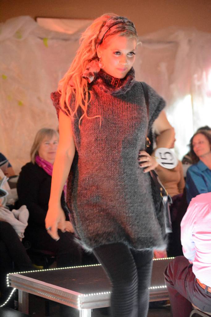 Britt Huffman models Grey Skies by Lynn Burt with a black leather bag by Mary Hayden at the 2018 Wearable Arts on Nov. 17, 2018, in Homer, Alaska. (Photo by Michael Armstrong/Homer News)