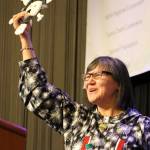 Alaska Lt. Gov. Valerie Davidson holds up an owl mask presented to her after addressing delegates at the annual Alaska Federation of Natives conference in Anchorage, Alaska, on Thursday, Oct. 18, 2018. Davidson was sworn in as lieutenant governor on Oct. 16, 2018, after Bryon Mallott resigned. (AP Photo/Mark Thiessen)
