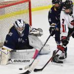 Homer goaltender Hunter Warren wards off a shot from Kenai skater Jacob Begich (7) Tuesday night at the Kenai Multi Purpose Facility. (Photo by Joey Klecka/Peninsula Clarion)