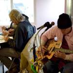 Live music is provided at the Kenai Peninsula Food Bank during an early Thanksgiving meal on Wednesday at its K-Beach Road facility near Soldotna. (Photo by Victoria Petersen/Peninsula Clarion)