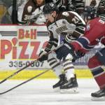Kenai River Brown Bears forward Jack Conroy brings the puck into the zone against Fairbanks Ice Dogs defenseman Lucas Erickson on Friday, Nov. 24, 2018, at the Soldotna Regional Sports Complex. (Photo by Jeff Helminiak/Peninsula Clarion)