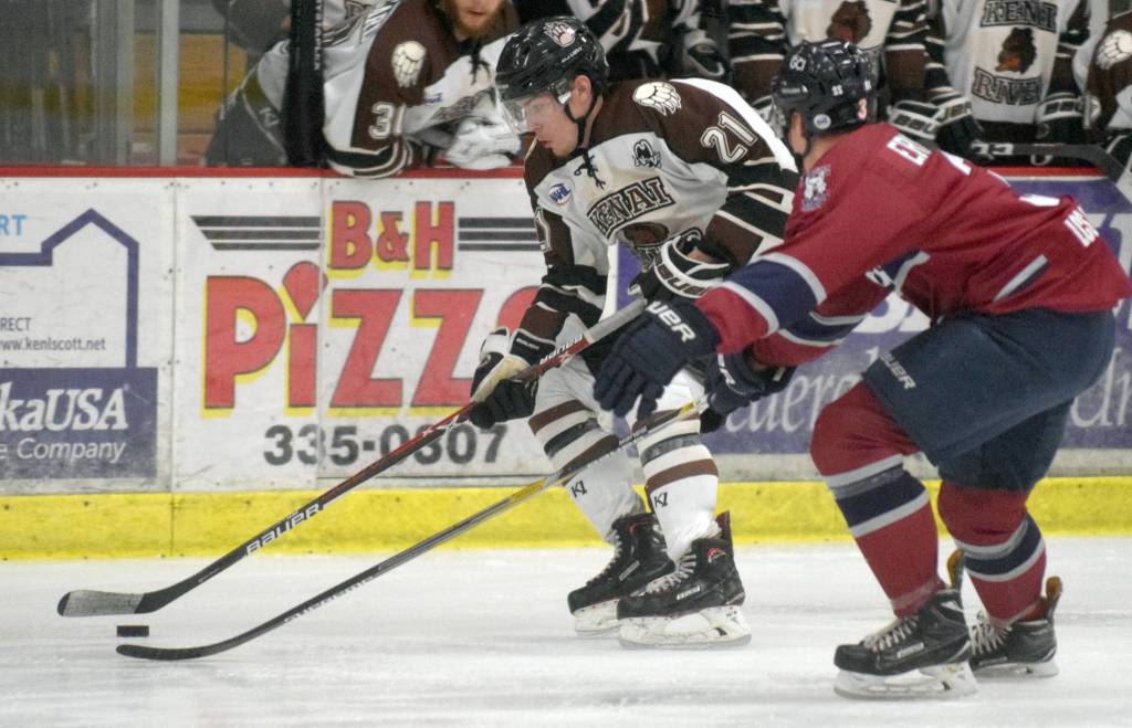 Kenai River Brown Bears forward Jack Conroy brings the puck into the zone against Fairbanks Ice Dogs defenseman Lucas Erickson on Friday, Nov. 24, 2018, at the Soldotna Regional Sports Complex. (Photo by Jeff Helminiak/Peninsula Clarion)