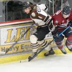 Kenai River Brown Bears defenseman Connor Canterbury and Fairbanks Ice Dogs forward Jack Johnston battle for the puck Sunday, Nov. 25, 2018, at the Soldotna Regional Sports Complex. (Photo by Jeff Helminiak/Peninsula Clarion)