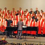 Kenai Central High School choir teacher Simon Nissen leads the schools choir during their annual holiday concert on Dec. 17 in Kenai Central High Schools Renee C. Henderson Auditorium. Students dressed in black were recognized this year as members of Alaskas All-State Choir. Kenai Central had 23 students honored by the program, the most out of any school in the state, according to Nissen. (Photo by Kat Sorensen/Peninsula Clarion)