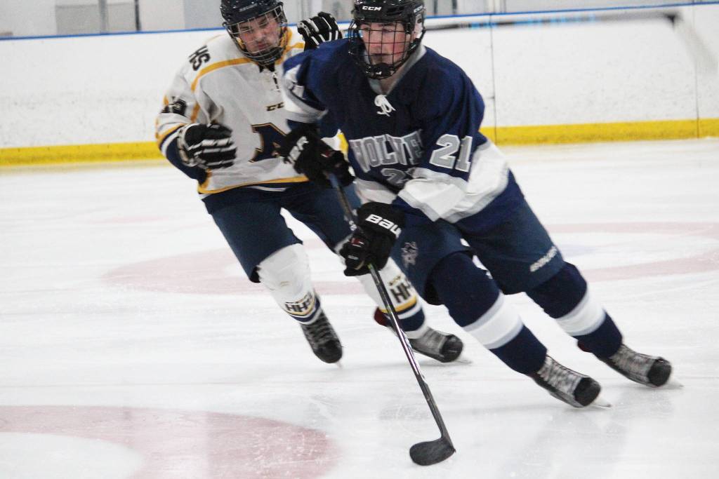 Eagle Rivers Marshall Yearman keeps the puck away from Homers Alden Ross during a game Thursday, Nov. 29, 2018 at the Kevin Bell Arena in Homer, Alaska. Eagle River beat the Mariners 8-0. (Photo by Megan Pacer/Homer News)