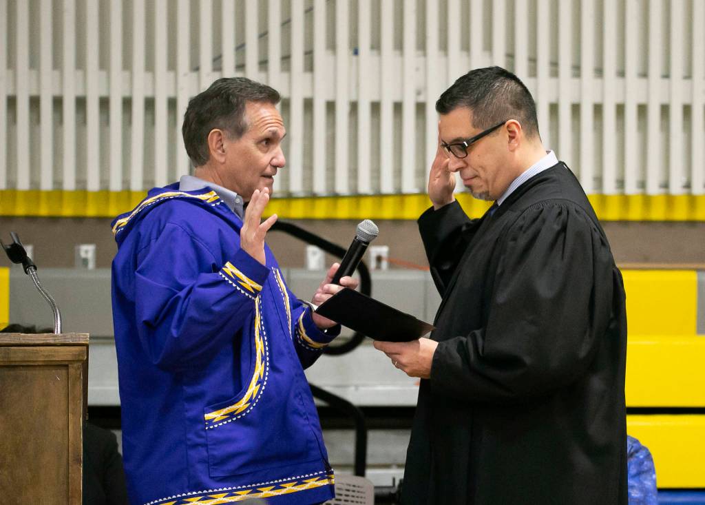 Kevin Meyer, left, is sworn into office as Alaskas lieutenant governor by Superior Court Judge Paul Roetman in Kotzebue, Alaska, on Monday, Dec. 3, 2018. Meyer was sworn into office before Mike Dunleavy took the oath as Alaskas governor. (Stanley Wright/Alaska Governors Office via AP)