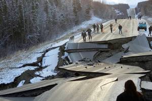 In this Nov. 30, 2018 file photo, provided by Jonathan M. Lettow, people walk along Vine Road after an earthquake in Wasilla, Alaska. Alaska State Troopers are asking that people do not take selfies in front of the buckled roadway north of Anchorage, Alaska. (Jonathan M. Lettow via AP, File)