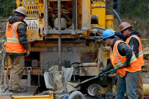 Workers obtain a soil sample near Autumn Road on Oct. 9, 2014, in Nikiski, where the Alaska LNG Project would locate a facility to cool natural gas into a liquid form for export. Alaska Gasline Development Corp. staff told federal regulators it plans to begin work to relocate a stretch of highway near the proposed site next year, although it still lacks funds for land acquisition or construction. (Photo/File/Rashah McChesney)