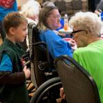 A student in April Kaufmans K-Beach Elementary kindergartner class practices introducing himself to residents at Heritage Place on Friday, Dec. 7, 2018, in Soldotna, Alaska. (Photo by Victoria Petersen/Peninsula Clarion)
