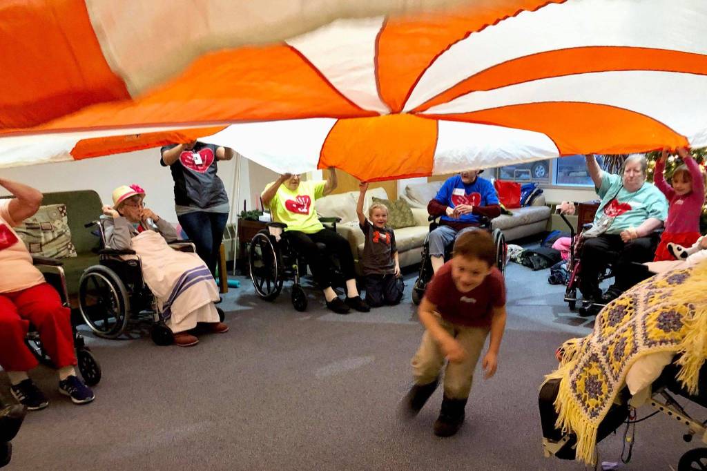 Kindergartners from K-Beach Elementary play games with residents from Heritage Place during a Dignity Mission activity on Friday, Dec. 7, 2018, in Soldotna, Alaska. (Photo by Victoria Petersen/Peninsula Clarion)