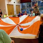 Kindergartners from K-Beach Elementary play games with residents from Heritage Place during a Dignity Mission activity on Friday, Dec. 7, 2018, in Soldotna, Alaska. (Photo by Victoria Petersen/Peninsula Clarion)