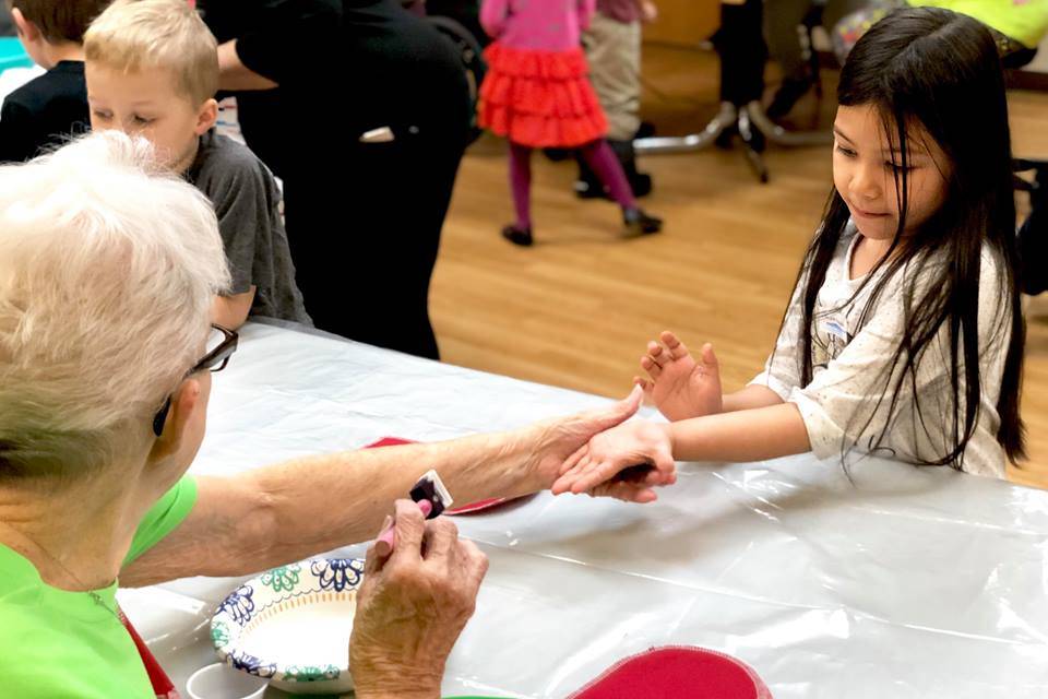 Residents from Heritage Place help kindergarten students make Dignity Mission T-shirts during a visit Friday in Soldotna. (Photo by Victoria Petersen/Peninsula Clarion)                                Residents from Heritage Place help kindergartner students make Dignity Mission T-shirts during a visit on Friday, Dec. 7, 2018, in Soldotna, Alaska. (Photo by Victoria Petersen/Peninsula Clarion)