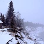 A building stands close to the edge of the Kenai River bluffs in February 2017. The bluffs are eroding at roughly 3 feet per year. (Ben Boettger/Peninsula Clarion file photo)