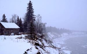 A building stands close to the edge of the Kenai River bluffs in February 2017. The bluffs are eroding at roughly 3 feet per year. (Ben Boettger/Peninsula Clarion file photo)