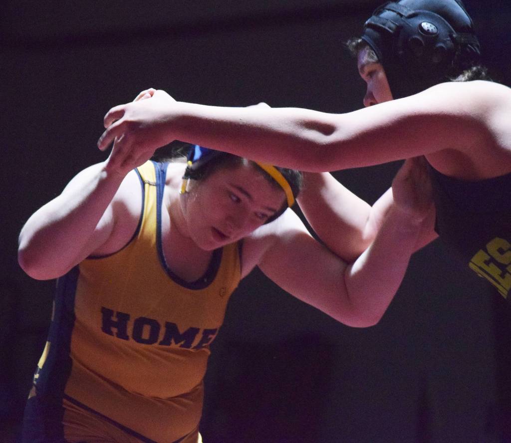 Homers Mariah Grimes (left) battles Redingtons Twyla Anderstrom for the girls 160-pound title Saturday at the Kachemak Conference wrestling tournament at Grace Christian High School in Anchorage. (Photo by Joey Klecka/Peninsula Clarion)