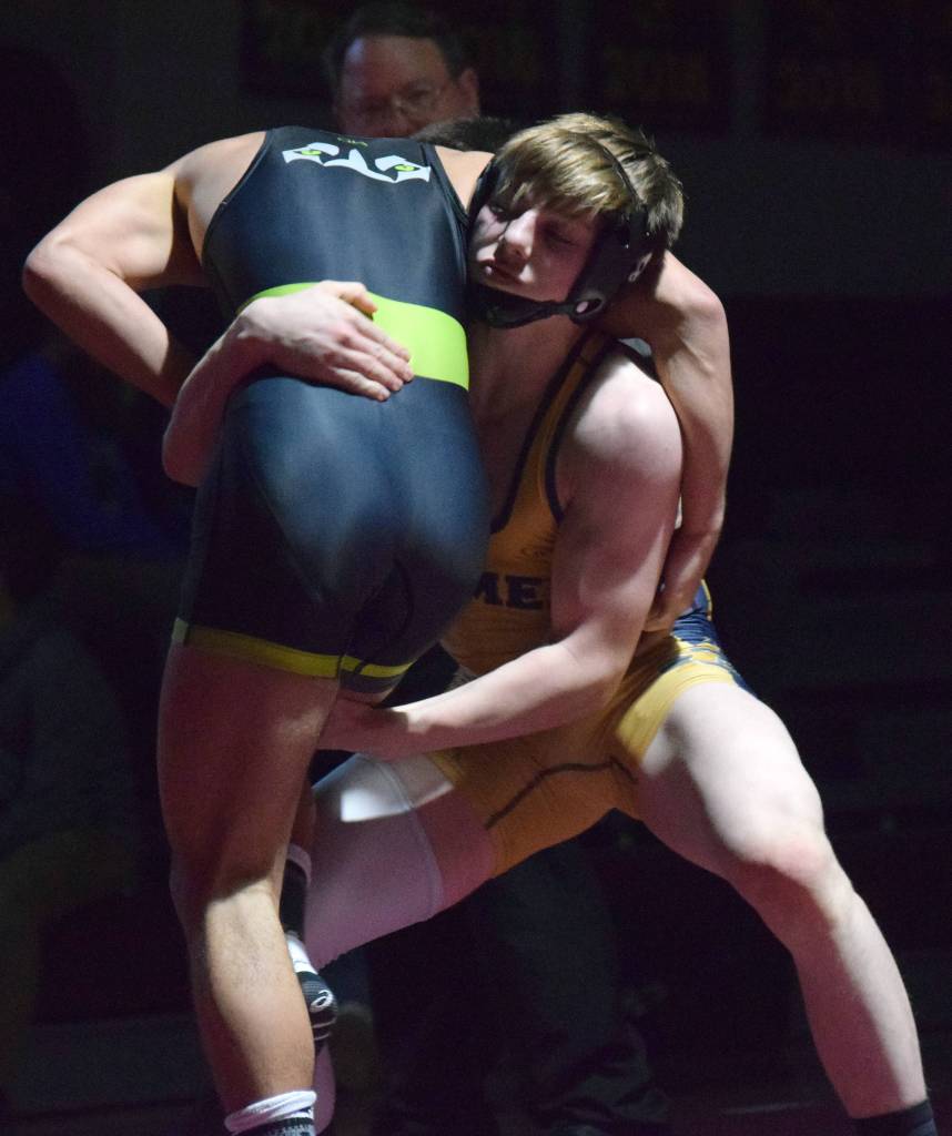 Homers Wayne Newman gains an advantage on Redingtons Gavin Metcalf Saturday in the 140-pound championship at the Kachemak Conference wrestling tournament at Grace Christian High School in Anchorage. (Photo by Joey Klecka/Peninsula Clarion)