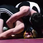 Nikiskis Jaryn Zoda battles against Caleb OHara of ACS Saturday in the 112-pound championship at the Kachemak Conference wrestling tournament at Grace Christian High School in Anchorage. (Photo by Joey Klecka/Peninsula Clarion)