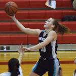 Nikiskis Bethany Carstens drives for a layup Thursday against Kotzebue at the Craig Jung Kenai River Challenge at Kenai Central High School. (Photo by Joey Klecka/Peninsula Clarion)