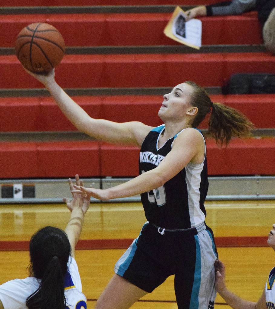 Nikiskis Bethany Carstens drives for a layup Thursday against Kotzebue at the Craig Jung Kenai River Challenge at Kenai Central High School. (Photo by Joey Klecka/Peninsula Clarion)