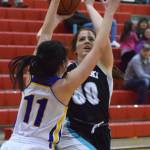Nikiskis Angela Druesedow drives against Kotzebues Ally Martin (11) Thursday at the Craig Jung Kenai River Challenge at Kenai Central High School. (Photo by Joey Klecka/Peninsula Clarion)