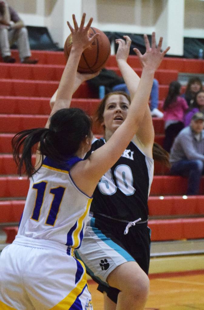 Nikiskis Angela Druesedow drives against Kotzebues Ally Martin (11) Thursday at the Craig Jung Kenai River Challenge at Kenai Central High School. (Photo by Joey Klecka/Peninsula Clarion)