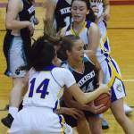 Nikiskis Kaitlyn Johnson grabs a rebound while Kotzebues Shylah Schaeffer (14) attempts to swipe it Thursday at the Craig Jung Kenai River Challenge at Kenai Central High School. (Photo by Joey Klecka/Peninsula Clarion)