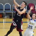 Nikolaevsks Justin Trail drives past Cook Inlet Academys James Anderson on Friday, Dec. 14, 2018, at Cook Inlet Academy in Soldotna. (Photo by Jeff Helminiak/Peninsula Clarion)