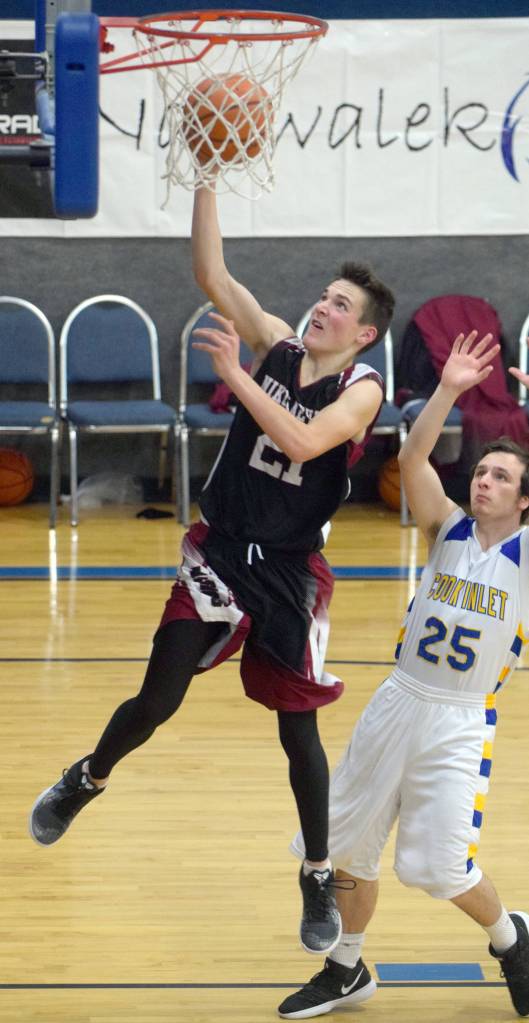 Nikolaevsks Justin Trail drives past Cook Inlet Academys James Anderson on Friday, Dec. 14, 2018, at Cook Inlet Academy in Soldotna. (Photo by Jeff Helminiak/Peninsula Clarion)
