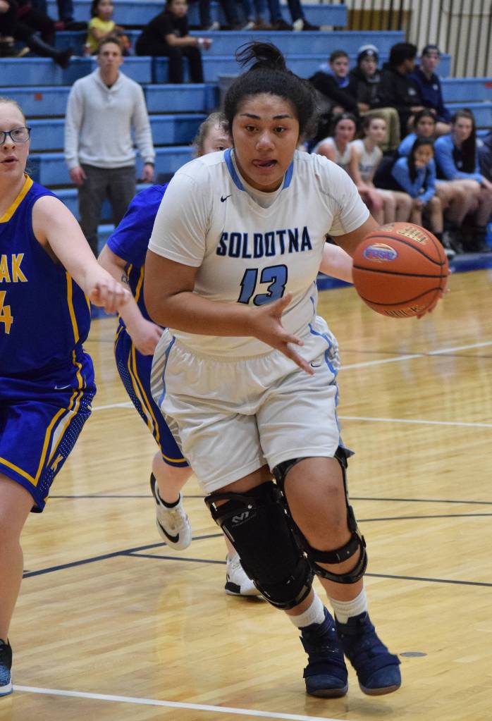 Soldotnas Ituau Tuisaula powers by a Kodiak defender Friday night at the Powerade/Al Howard Tip-Off tournament at Soldotna. (Photo by Joey Klecka/Peninsula Clarion)
