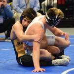Homer senior Luciano Fasulo works on Dillinghams Chris Williams in the 135-pound final Saturday night at the Div. II state wrestling championships at the Alaska Airlines Center in Anchorage. (Photo by Joey Klecka/Peninsula Clarion)