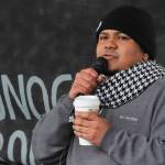 Manni Guillen, whose family moved to Juneau from Mexico when he was a baby, speaks at the Love Knows No Borders rally in Juneau on Saturday, Dec. 15, 2018. Guillen spoke about his experiences growing up in Juneau and working with the Border Angels nonprofit. (Alex McCarthy | Juneau Empire)