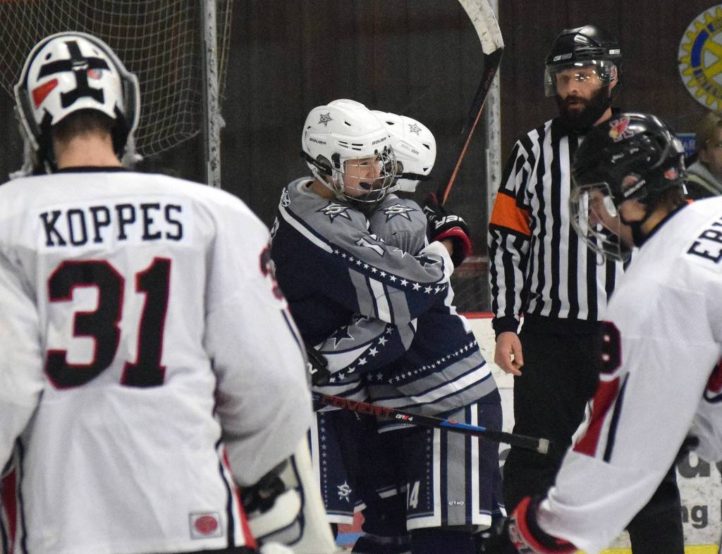 Soldotna junior David Aley is congratulate by teammates Thursday evening after scoring on Kenai Central at the Kenai Multi-Purpose Facility. (Photo by Joey Klecka/Peninsula Clarion)