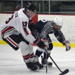 Soldotnas Josh OLena attempts to steal the puck from Kenai Centrals Aidan Milburn (13) Thursday evening at the Kenai Multi-Purpose Facility. (Photo by Joey Klecka/Peninsula Clarion)
