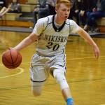 Nikiski guard Jace Kornstad dribbles the ball up the floor Feb. 25, 2017, against Grace Christian. (Photo by Joey Klecka/Peninsula Clarion)