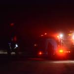 Kachemak Emergency Services firefighters blocked off the Sterling Highway at Diamond Ridge Road at about 10:20 p.m. Thursday, Dec. 27, 2018, in Homer Alaska. (Photo by Michael Armstrong/Homer News)