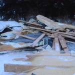 Debris from an exploded house is piled by the road near Mile 166 Sterling Highway on Friday, Dec. 28, 2018, near Homer, Alaska. The debris field from the explosion spread at least 200 feet in all directions. (Photo by Michael Armstrong/Homer News).
