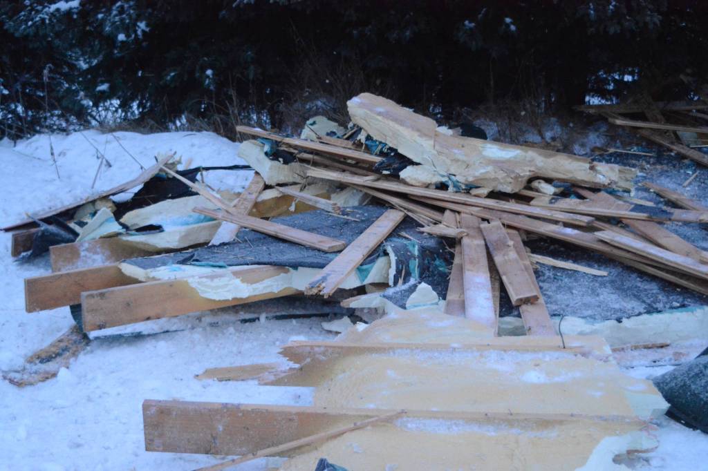Debris from an exploded house is piled by the road near Mile 166 Sterling Highway on Friday, Dec. 28, 2018, near Homer, Alaska. The debris field from the explosion spread at least 200 feet in all directions. (Photo by Michael Armstrong/Homer News).