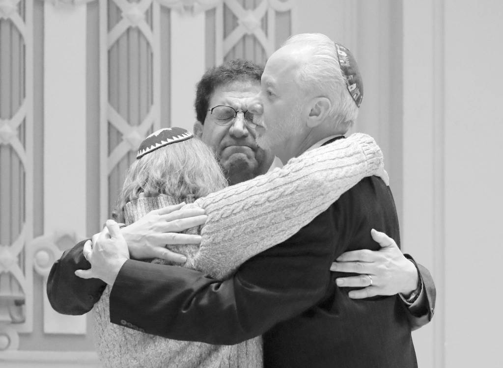In this Oct. 28 file photo, Rabbi Jeffrey Myers, right, of Tree of Life/Or LSimcha Congregation hugs Rabbi Cheryl Klein, left, of Dor Hadash Congregation and Rabbi Jonathan Perlman during a community gathering held in the aftermath of a deadly shooting at the Tree of Life Synagogue in Pittsburgh. (AP Photo/Matt Rourke, File)