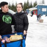 Jerry Arizpe and his wife, Jordan, hold a 33-pound bag of food they picked up at the Southeast Alaska Food Bank on Monday, Jan 21, 2019. Arizpe is a U.S. Coast Guardsman at Station Juneau and is not currently receiving a paycheck because of the partial federal shutdown. (Michael Penn | Juneau Empire)
