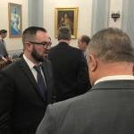 Department of Administration Commissioner Designee John Quick, left, speaks with senators after talking to the Senate Finance Committee on Tuesday, Jan. 22, 2019. (Alex McCarthy | Juneau Empire)