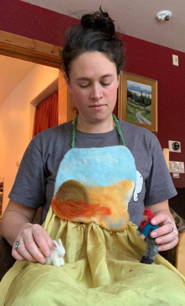 Hanna Young shows her story apron, a surface for telling stories using her felted characters. (Photo provided)